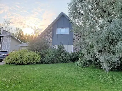 A house with a tree in front of it.