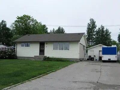 A house with a truck parked in front of it.