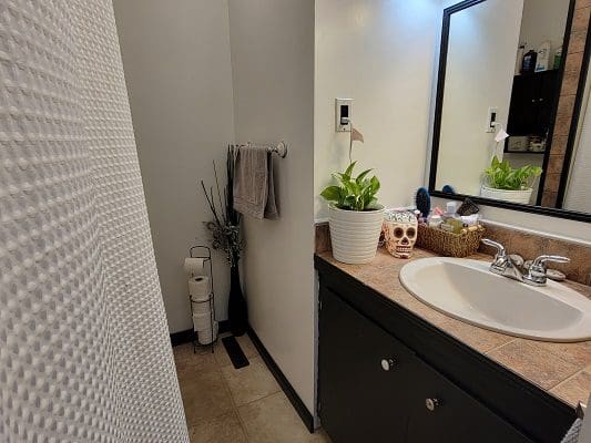A bathroom with a sink, toilet and shower.