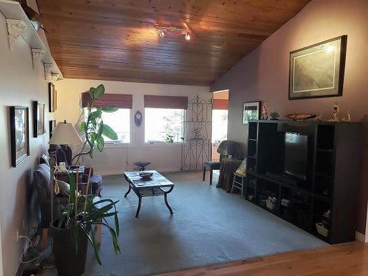 A living room with hardwood floors and a tv.