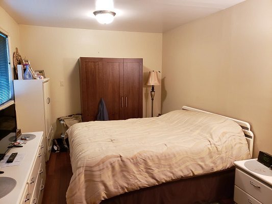 A bedroom with a bed and a desk.