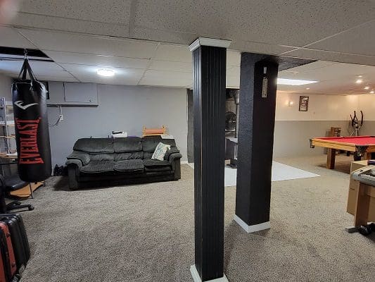 A basement with a pool table and billiard table.