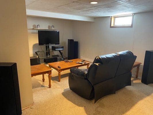 A living room with a tv and speakers.