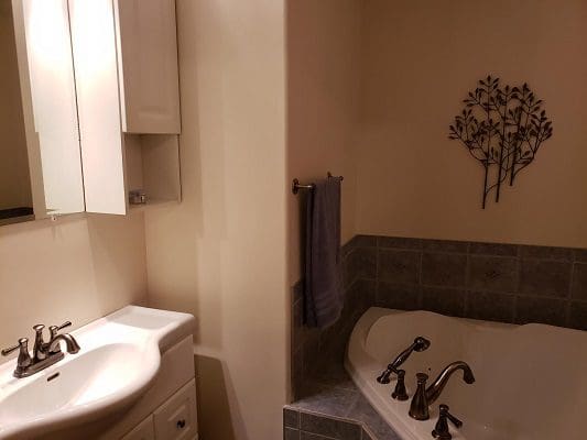 A bathroom with a bathtub and sink.
