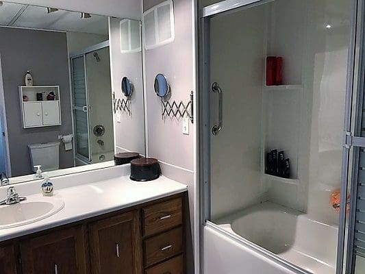 A bathroom with a sink, toilet and shower.