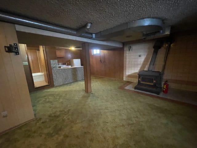 A room with a fireplace and a stove.