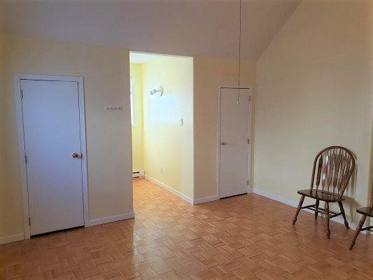A room with two doors and a chair.