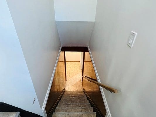 A stairway leading up to a room in a house.