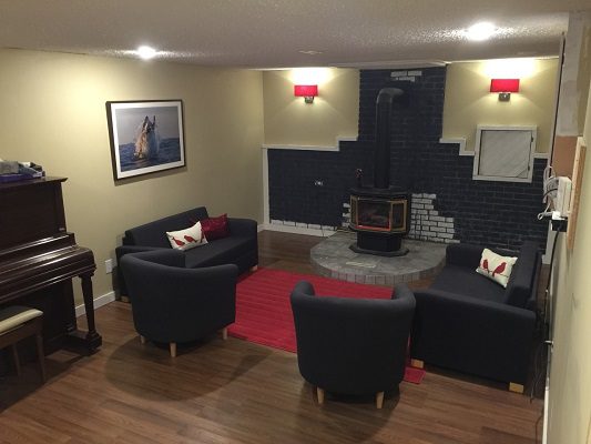 A living room with couches and a piano.