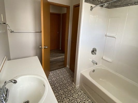A bathroom with a bathtub and sink.