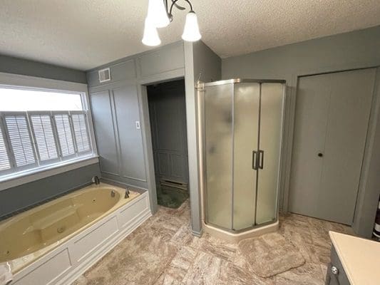 A bathroom with a bathtub and shower.