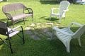 A group of lawn chairs and a fire pit in a yard.