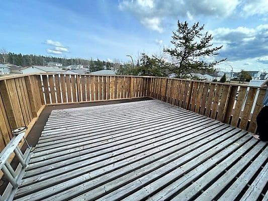 A person is standing on a wooden deck.
