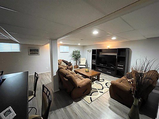 A living room with couches and a tv.