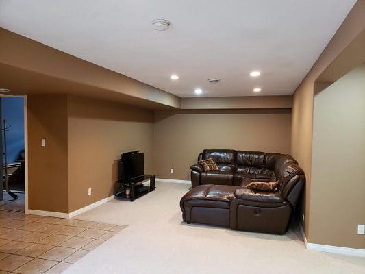 A living room with couches and a television.