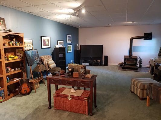 A living room with a tv and bookshelves.