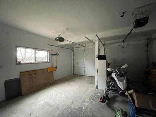 An empty garage with a motorcycle in it.