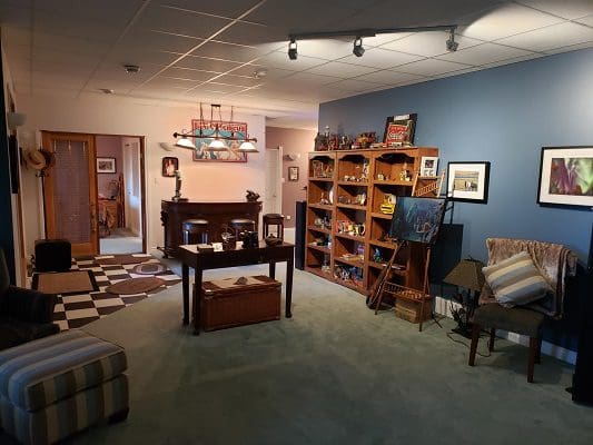 A room with bookshelves and a fireplace.