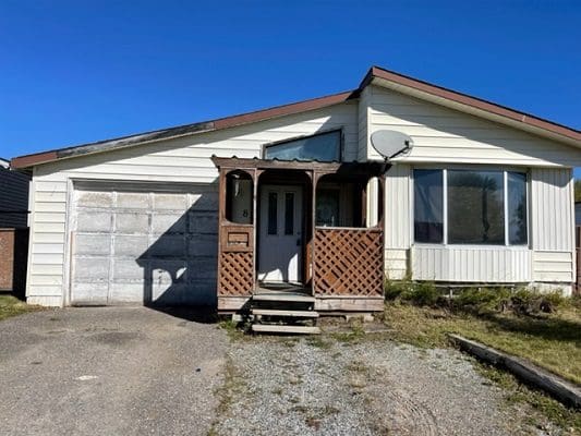 A house with a garage in front of it.