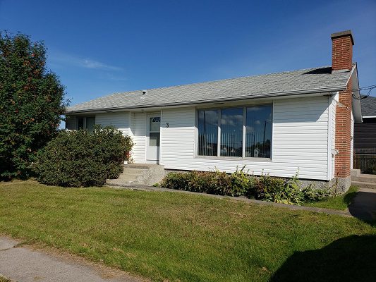 A house with a lawn in front of it.