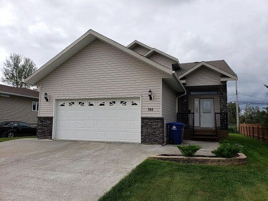 A house with a garage in front of it.