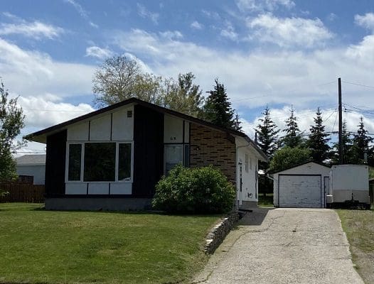 A house with a driveway and a garage in front of it.