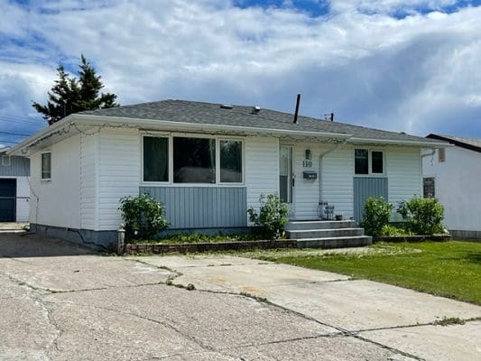 A house with a garage in front of it.