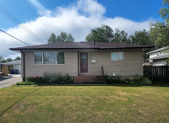 A house with a yard in front of it.