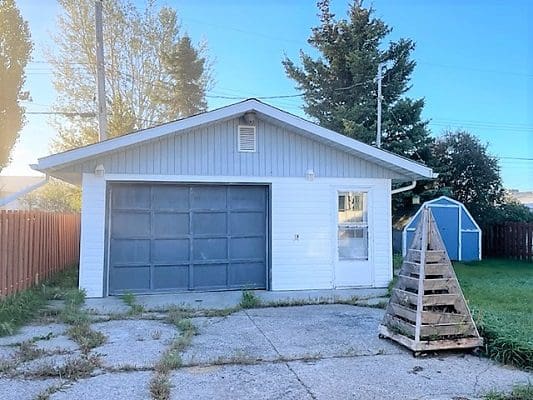 A house with a garage in the backyard.