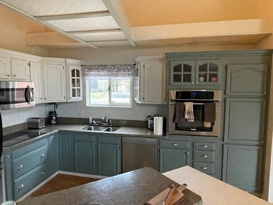 A kitchen with blue and white cabinets.