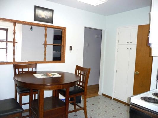 A small kitchen with a table and chairs.