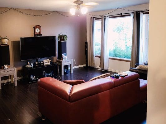 A living room with hardwood floors and a tv.