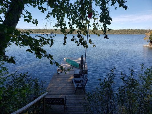 A dock on a lake with a boat on it.