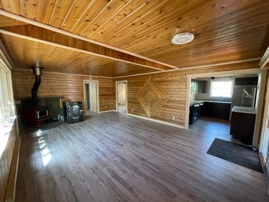 A living room with wood floors and a fireplace.