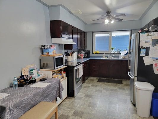 A kitchen with a microwave and a refrigerator.