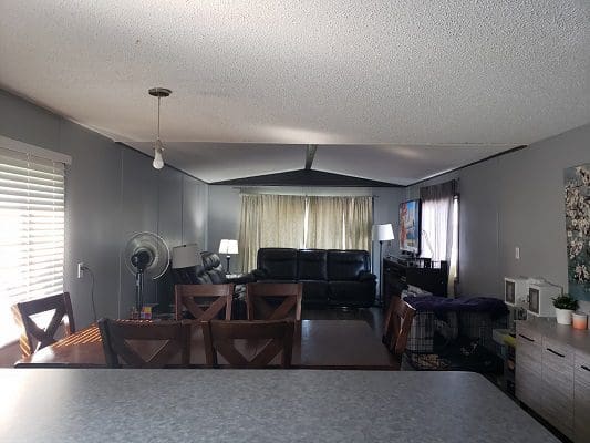 A living room with a dining table and chairs.