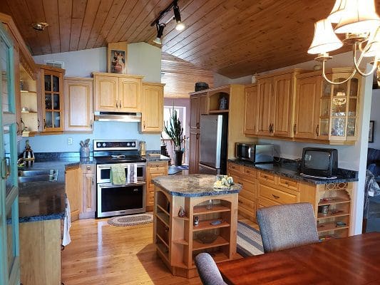 A kitchen or kitchenette in a home with wood cabinets.