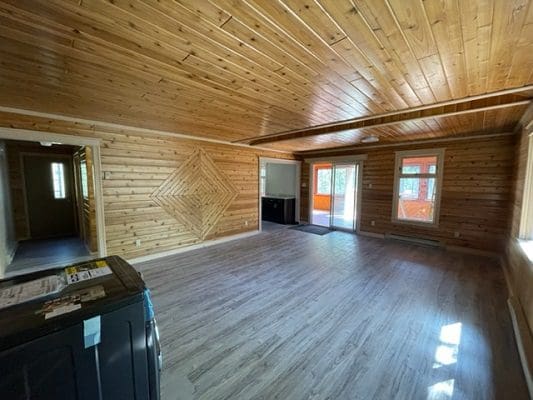 A living room with wood floors and a fireplace.