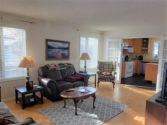 A living room with a couch, tv, and a coffee table.