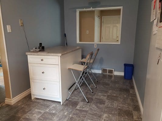 A small kitchen with a table and chairs.