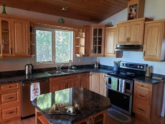 A kitchen with wood cabinets and stainless steel appliances.