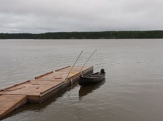 Wooden Dock and Black Canoe