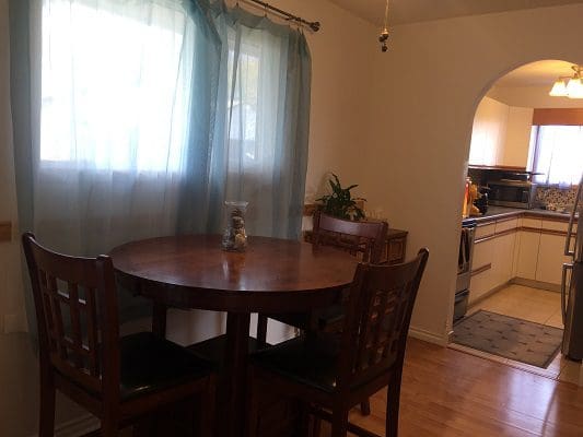 A small kitchen with a table and chairs.