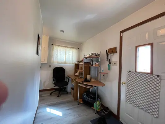 A small room with a desk and chair.