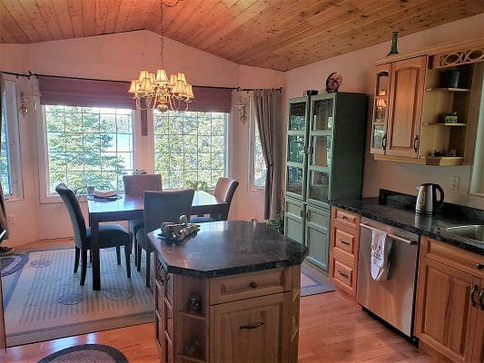 A kitchen with hardwood floors and a dining table.