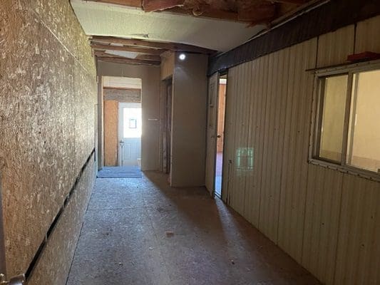 A hallway in an unfinished building.