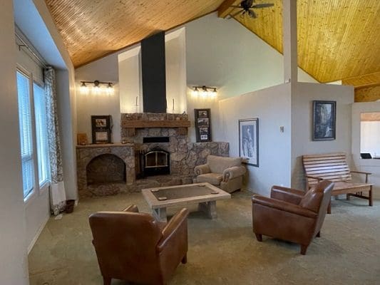 A living room with couches and a fireplace.