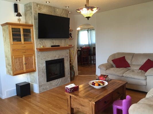 A living room with a fireplace and tv.