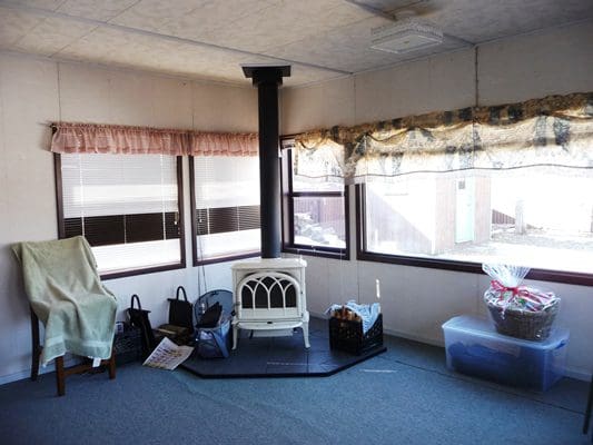 A room with a stove and a window.