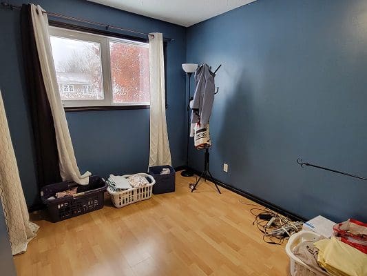 A room with blue walls and a window.